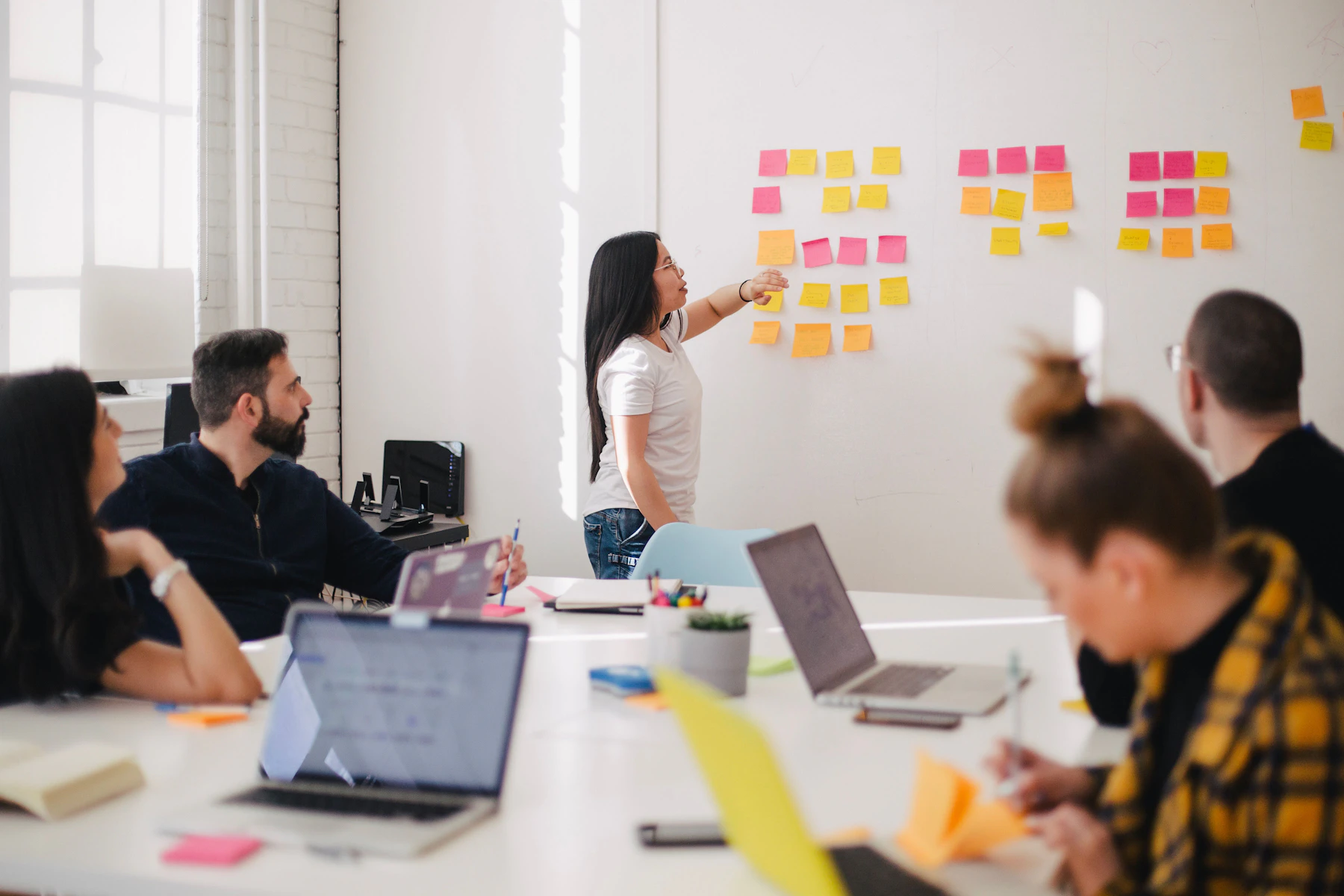 A facilitator mapping a workflow with colleagues